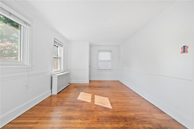 1216 Laclair Ave, Regent Square, PA 15218 - empty room featuring radiator heating unit, wood finished floors, plenty of natural light, and ornamental molding