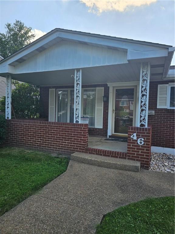 46 Corbett Ave, Hempfield Twp Wml, PA 15642 - view of front of home with a porch and brick siding