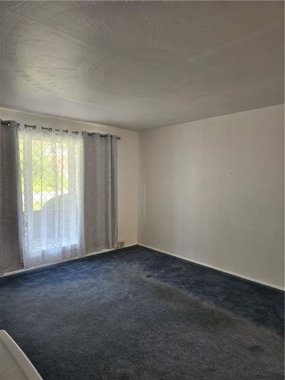 46 Corbett Ave, Hempfield Twp Wml, PA 15642 - empty room with dark colored carpet and baseboards