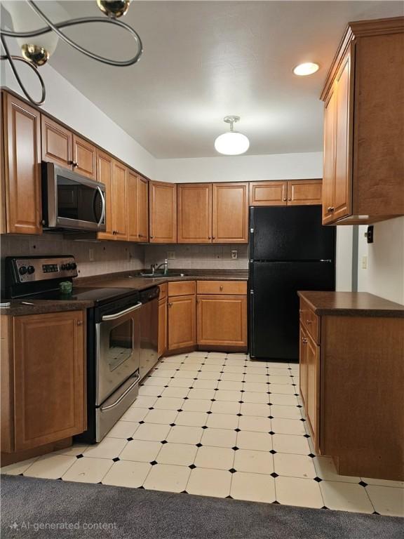 46 Corbett Ave, Hempfield Twp Wml, PA 15642 - kitchen featuring appliances with stainless steel finishes, dark countertops, light flooring, brown cabinetry, and recessed lighting