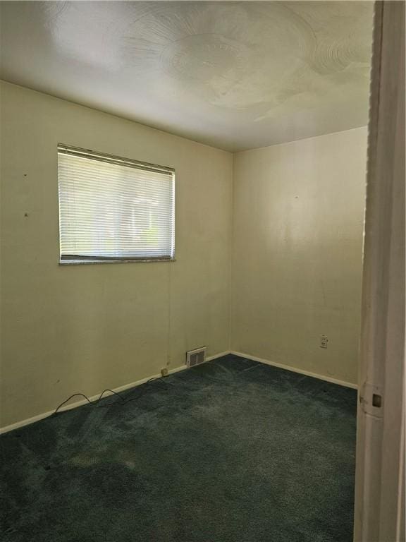 46 Corbett Ave, Hempfield Twp Wml, PA 15642 - empty room featuring dark carpet and baseboards