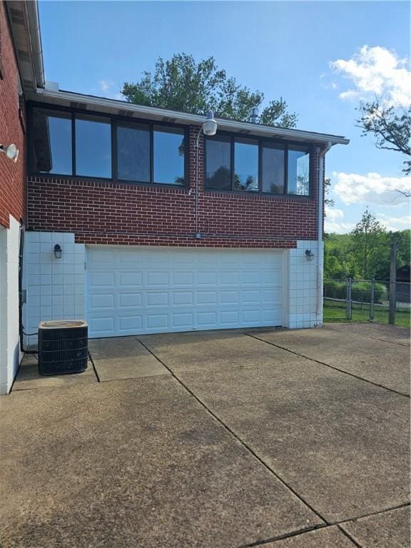 46 Corbett Ave, Hempfield Twp Wml, PA 15642 - view of front of property featuring concrete driveway, an attached garage, and brick siding