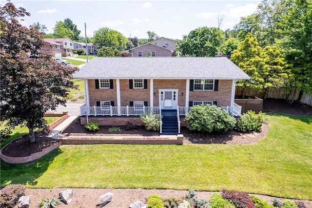 25 Nottingham Dr, Hempfield Twp, PA 15601 - raised ranch featuring covered porch, brick siding, and roof with shingles
