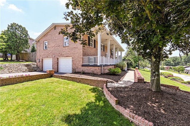 25 Nottingham Dr, Hempfield Twp, PA 15601 - view of side of property featuring a garage, a porch, driveway, and brick siding