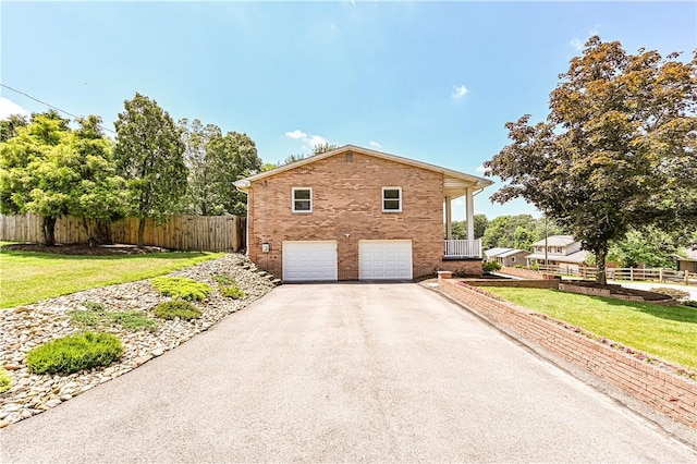 25 Nottingham Dr, Hempfield Twp, PA 15601 - view of property exterior featuring driveway, an attached garage, and brick siding