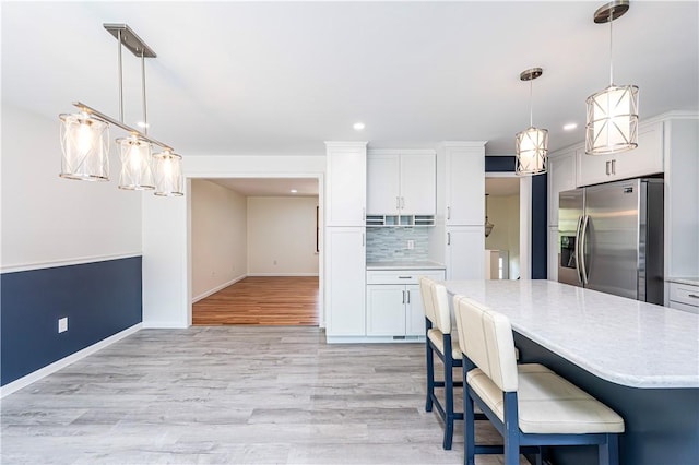 25 Nottingham Dr, Hempfield Twp, PA 15601 - kitchen with stainless steel fridge with ice dispenser, light wood-type flooring, white cabinetry, backsplash, and recessed lighting