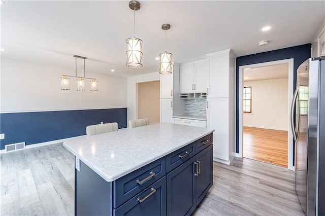 25 Nottingham Dr, Hempfield Twp, PA 15601 - kitchen with freestanding refrigerator, white cabinets, light wood finished floors, decorative backsplash, and recessed lighting