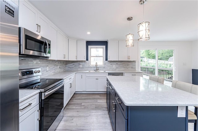 25 Nottingham Dr, Hempfield Twp, PA 15601 - kitchen featuring stainless steel appliances, plenty of natural light, a kitchen bar, white cabinetry, and recessed lighting