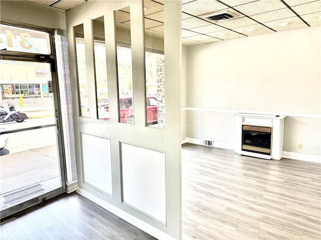 314-316 W Main St, Monongahela, PA 15063 - doorway to outside with wood finished floors, heating unit, a glass covered fireplace, and a paneled ceiling