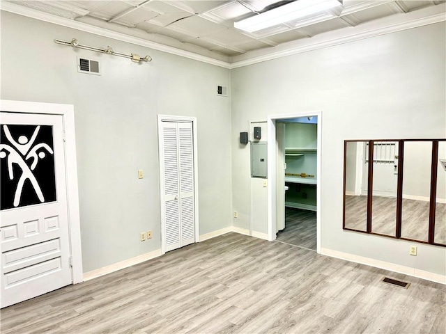 314-316 W Main St, Monongahela, PA 15063 - empty room featuring wood finished floors, a towering ceiling, and crown molding