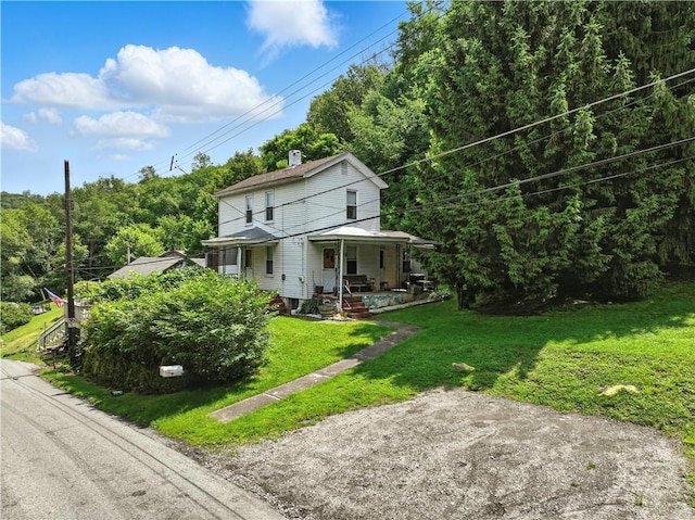 3114 30th St, Pulaski Twp Bea, PA 15066 - view of front of home featuring a porch, a front yard, a chimney, and a wooded view