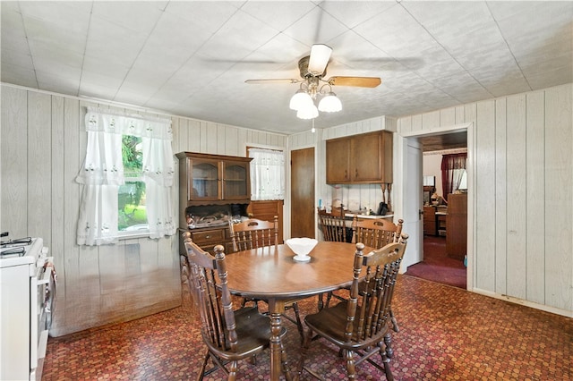 3114 30th St, Pulaski Twp Bea, PA 15066 - dining space featuring dark floors, wood walls, and ceiling fan