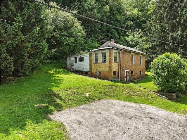 3114 30th St, Pulaski Twp Bea, PA 15066 - view of home's exterior with a chimney, a lawn, and brick siding