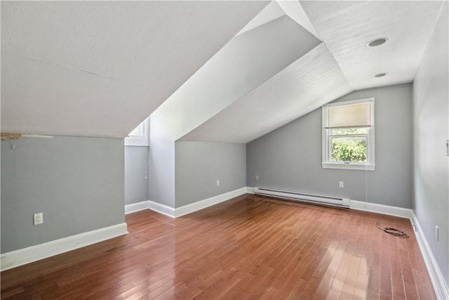 2617-2619 Spring Garden Ave, Spring Garden, PA 15212 - bonus room featuring a baseboard radiator, vaulted ceiling, and hardwood / wood-style floors