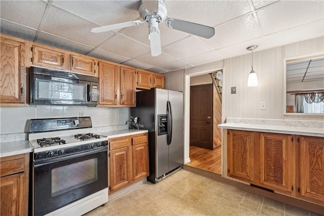 2617-2619 Spring Garden Ave, Spring Garden, PA 15212 - kitchen featuring black microwave, white gas stove, stainless steel fridge, a paneled ceiling, and brown cabinets