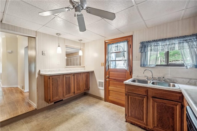 2617-2619 Spring Garden Ave, Spring Garden, PA 15212 - kitchen featuring brown cabinets, a paneled ceiling, light countertops, hanging light fixtures, and ceiling fan