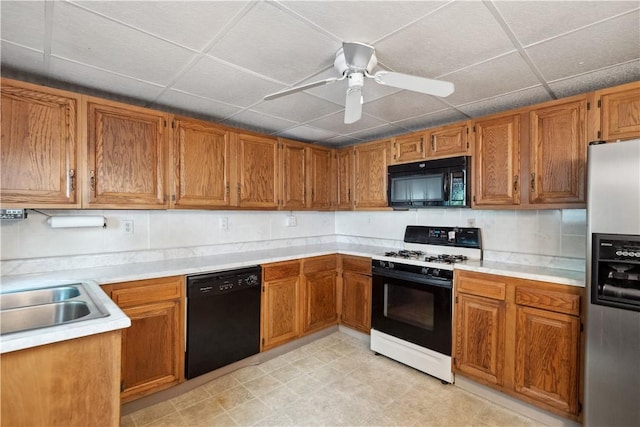 2617-2619 Spring Garden Ave, Spring Garden, PA 15212 - kitchen with black appliances, brown cabinetry, light countertops, a ceiling fan, and a drop ceiling