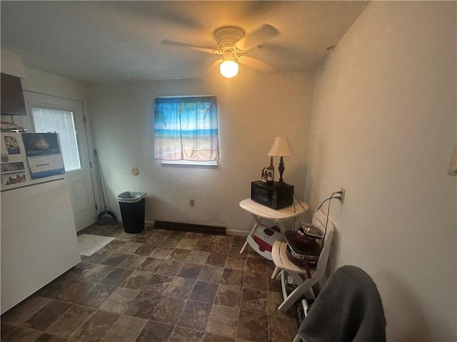 100 Quarry St, Rochester, PA 15074 - dining room featuring washer / dryer, ceiling fan, and dark stone finish floors