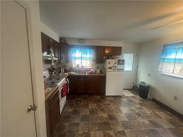 100 Quarry St, Rochester, PA 15074 - kitchen featuring white appliances, stone finish floors, ventilation hood, and dark brown cabinetry