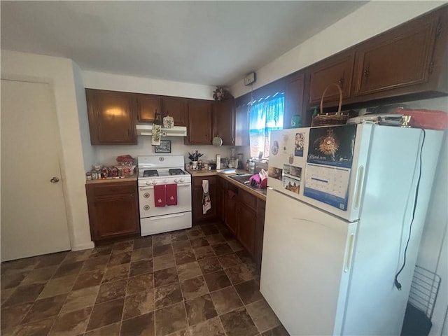 100 Quarry St, Rochester, PA 15074 - kitchen featuring white appliances, ventilation hood, dark stone finish flooring, dark brown cabinets, and light countertops
