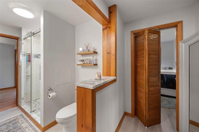 367 Crescent Dr, Canton Twp, PA 15301 - bathroom with a shower stall, a closet, and wood finished floors
