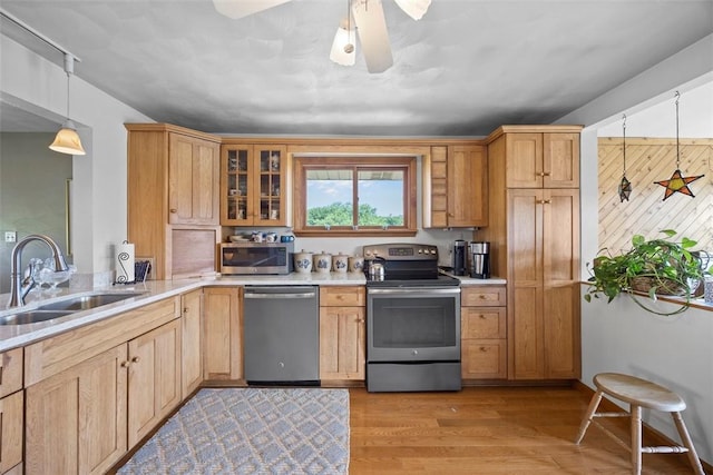 367 Crescent Dr, Canton Twp, PA 15301 - kitchen with stainless steel appliances, light countertops, light wood-style floors, glass insert cabinets, and ceiling fan