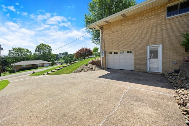 367 Crescent Dr, Canton Twp, PA 15301 - view of side of home featuring driveway, brick siding, and a garage