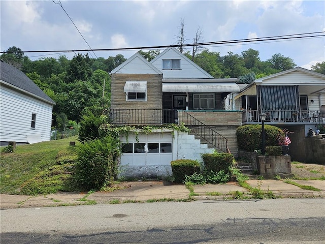 311 Euclid Ave, Glassport, PA 15045 - view of front of house featuring stairs, a garage, and a porch