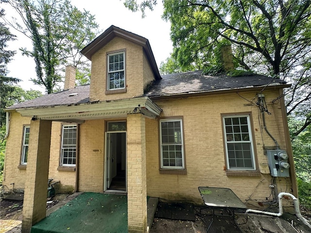 535 Chautauqua St, Perry Hilltop, PA 15214 - back of property featuring a chimney, brick siding, and roof with shingles