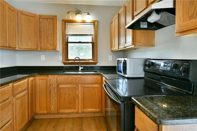 49 N Oakdale Ave, Hermitage, PA 16148 - kitchen with black range with electric stovetop, ventilation hood, light wood finished floors, and dark stone counters