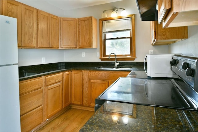 49 N Oakdale Ave, Hermitage, PA 16148 - kitchen with white appliances, light wood finished floors, dark stone countertops, and brown cabinets