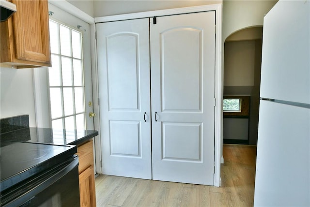 49 N Oakdale Ave, Hermitage, PA 16148 - kitchen with freestanding refrigerator, light wood finished floors, and dark countertops