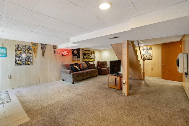 2534 Jefferson Ave, West Mifflin, PA 15122 - carpeted living room with wood walls, stairway, and a drop ceiling