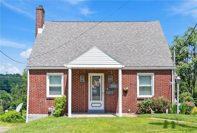 2534 Jefferson Ave, West Mifflin, PA 15122 - view of front of home with a chimney, brick siding, and a shingled roof