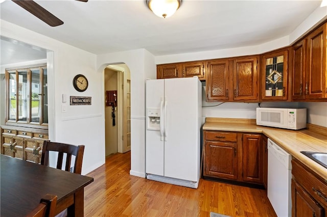 2534 Jefferson Ave, West Mifflin, PA 15122 - kitchen featuring white appliances, arched walkways, light countertops, glass insert cabinets, and ceiling fan