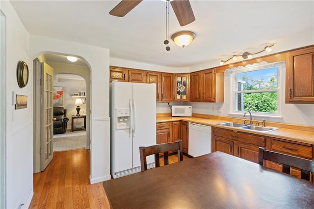 2534 Jefferson Ave, West Mifflin, PA 15122 - kitchen featuring white appliances, a ceiling fan, brown cabinetry, and wood finished floors