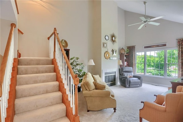135 Linden Ct, Seven Fields Boro, PA 16046 - living area featuring high vaulted ceiling, carpet flooring, stairs, a fireplace with flush hearth, and a ceiling fan