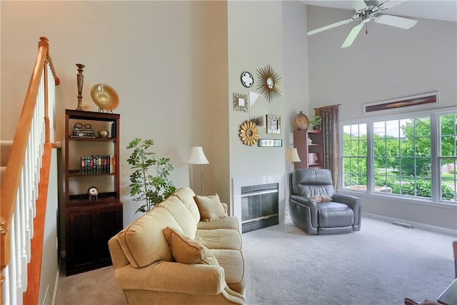 135 Linden Ct, Seven Fields Boro, PA 16046 - carpeted living room featuring a tile fireplace, high vaulted ceiling, and a ceiling fan