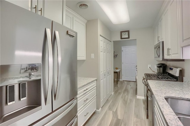 135 Linden Ct, Seven Fields Boro, PA 16046 - kitchen featuring stainless steel appliances, white cabinetry, light stone countertops, and light wood-type flooring
