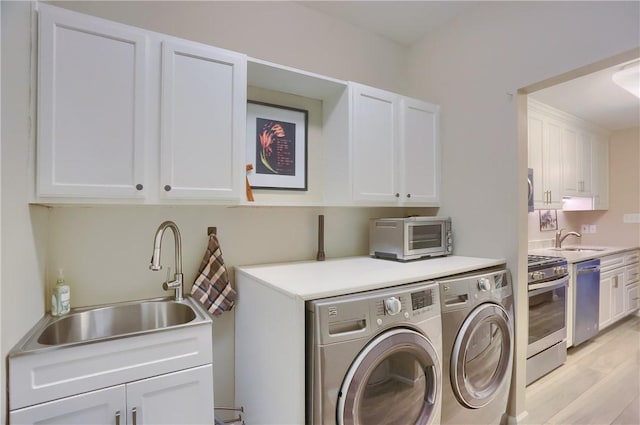 135 Linden Ct, Seven Fields Boro, PA 16046 - laundry area featuring independent washer and dryer, cabinet space, and light wood-style floors