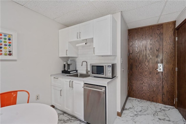 200 Commerce Dr Unit 210, Moon/Crescent Twp, PA 15108 - kitchen with stainless steel dishwasher, light marble finish flooring, white cabinetry, light countertops, and a paneled ceiling
