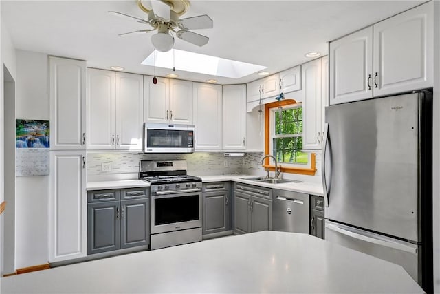 236 Fredonia Rd, Hempfield Twp Mer, PA 16125 - kitchen featuring stainless steel appliances, gray cabinetry, a ceiling fan, a skylight, and recessed lighting