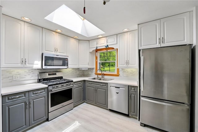 236 Fredonia Rd, Hempfield Twp Mer, PA 16125 - kitchen with appliances with stainless steel finishes, gray cabinets, a skylight, white cabinets, and recessed lighting