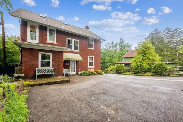 35 Pleasant Valley Rd, Hempfield Twp Wml, PA 15644 - view of front facade featuring brick siding, a chimney, and asphalt driveway