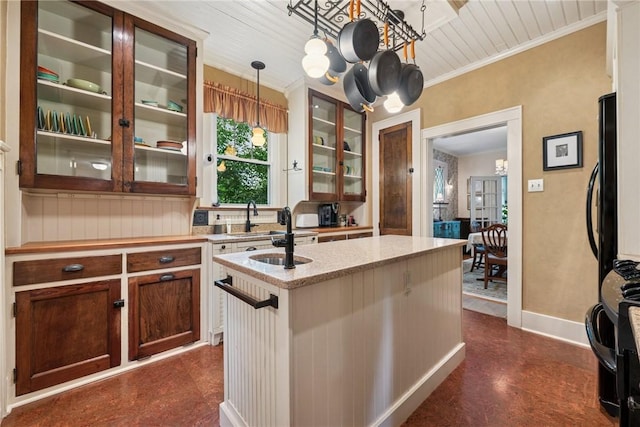 35 Pleasant Valley Rd, Hempfield Twp Wml, PA 15644 - kitchen with a chandelier, glass insert cabinets, hanging light fixtures, a kitchen island with sink, and light stone counters