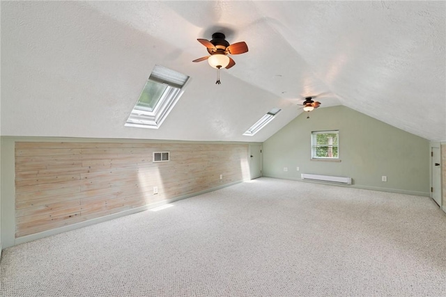 35 Pleasant Valley Rd, Hempfield Twp Wml, PA 15644 - additional living space featuring a baseboard radiator, ceiling fan, a skylight, vaulted ceiling, and carpet floors