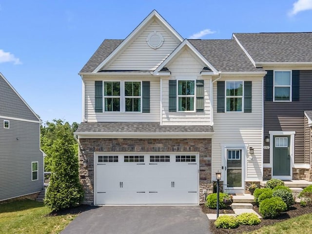 134 Black Oak Ln, Cecil, PA 15057 - view of front of property featuring a garage, asphalt driveway, stone siding, and roof with shingles