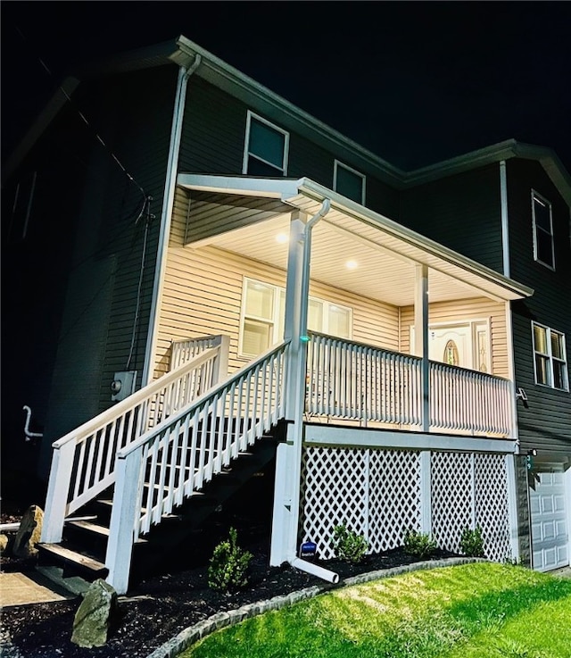 39 Delmont Ave, Delmont, PA 15626 - view of side of property featuring covered porch, stairs, and an attached garage