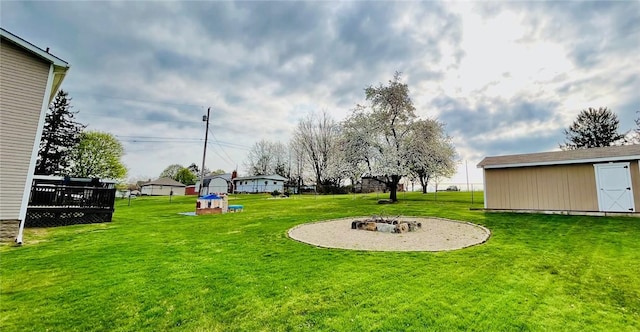39 Delmont Ave, Delmont, PA 15626 - view of green lawn with an outdoor fire pit, an outdoor structure, and a deck