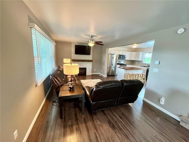 39 Delmont Ave, Delmont, PA 15626 - living room featuring ceiling fan, dark wood finished floors, and a stone fireplace